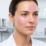 Model wearing Salmon PDRN patches on the forehead, under-eye and nasolabial zones. Illustrative imagery.